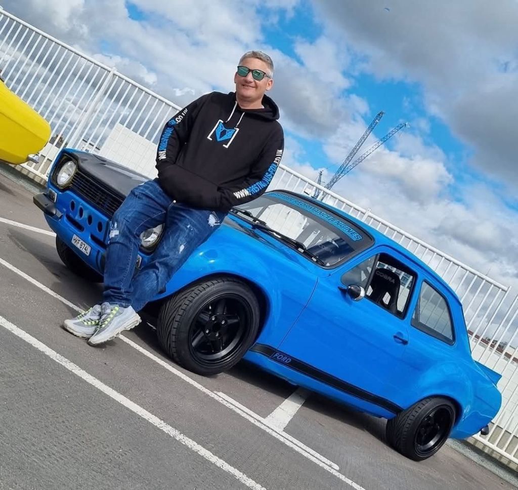 Dean Lewis proudly standing in fromt of his beloved Mk1 Ford escort